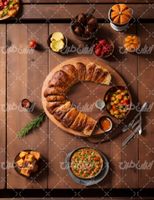 تصویر با کیفیت میز غذاخوری چوبی همراه مواد غذایی و نان