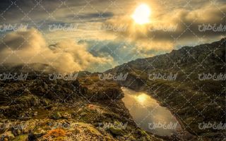 تصویر با کیفیت منظره غروب آفتاب همراه با کوهستان و ابر