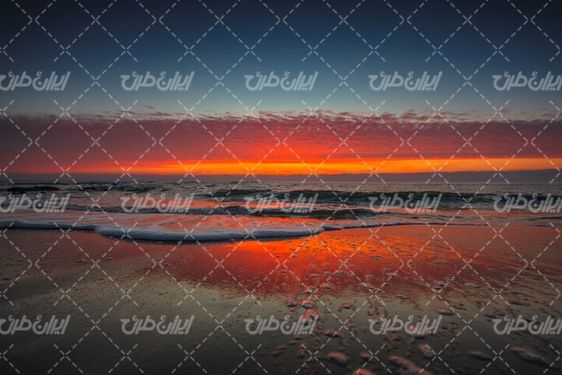 تصویر با کیفیت منظره زیبای دریا همراه با غروب آفتاب و چشم انداز