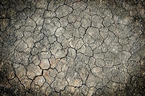 پس زمینه زمین ترک خرده خاکستری 
