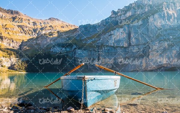 تصویر با کیفیت منظره کوه همراه با دریاچه و قایق پارویی