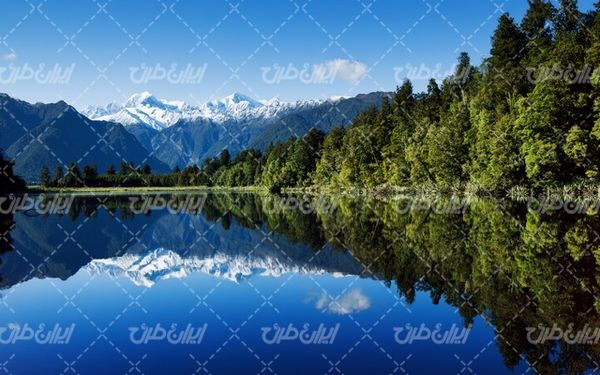 تصویر با کیفیت منظره دریاچه همراه با کوه و درخت