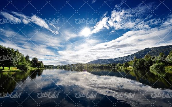تصویر با کیفیت دریاچه زیبا به همراه آسمان آبی و آب زلال