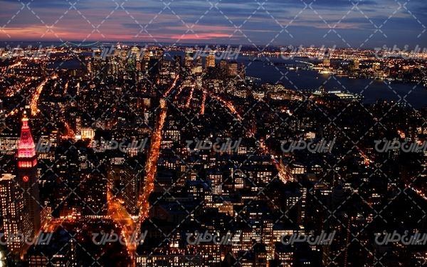 تصویر با کیفیت غروب آفتاب همراه با عکس شهر و ساختمان